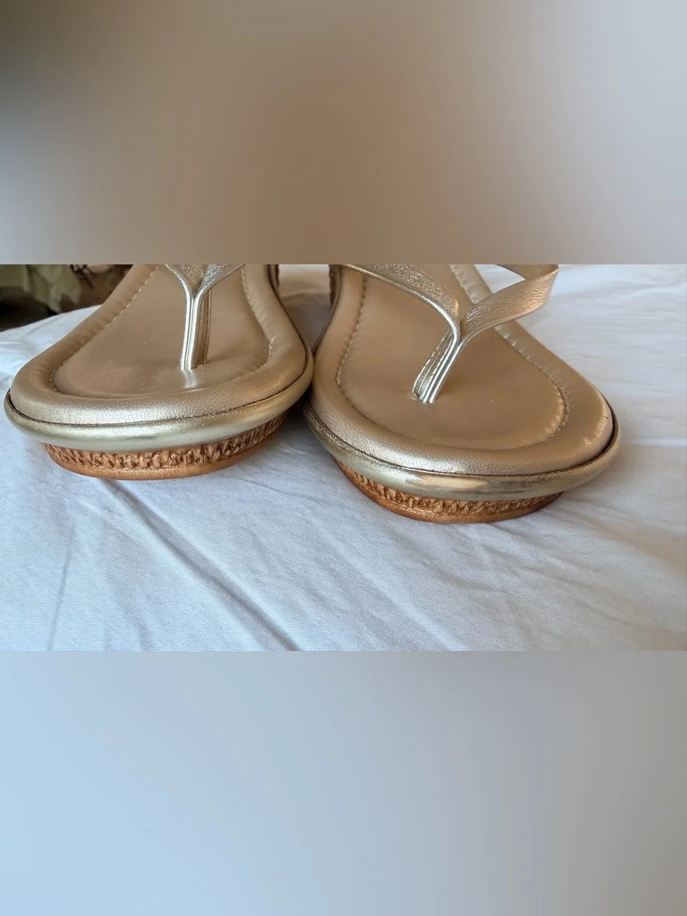 Italian Shoemakers thong wedge sandals feature a metallic gold finish